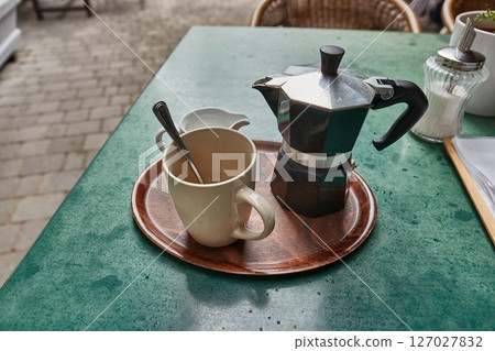Coffee served in moka pot on a terrace Coffee served in moka pot on a terrace 127027832