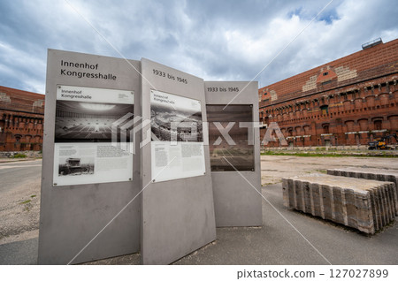 Nuremberg, Germany, August 3, 2023. View inside the abandoned Nazi Congress Hall building. Information panels with vintage photos. Travel destinations. 127027899