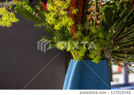 A bouquet in a blue vase 127028148