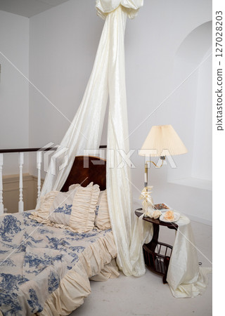 Cozy Bedroom with Canopy and Nightstand Scene Cozy Bedroom with Canopy and Nightstand Scene 127028203