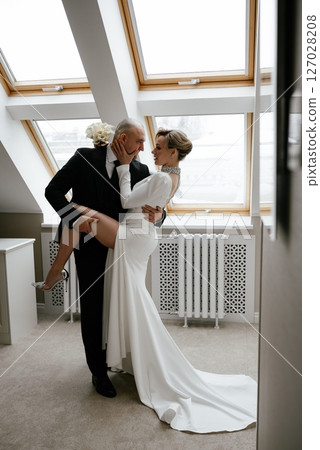 Romantic Wedding Dance in Sunlit Room 127028208