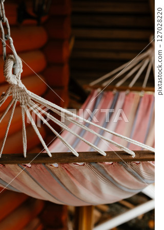 Cozy Hammock on Rustic Wooden Porch 127028220