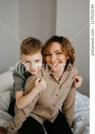 Mother and Son Sharing a Joyful Moment on Bed 127028240