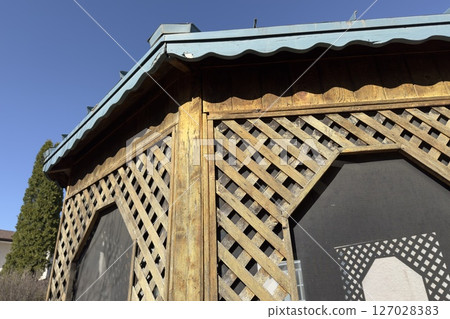 wooden lattice gazebo against blue sky wooden lattice gazebo against blue sky 127028383