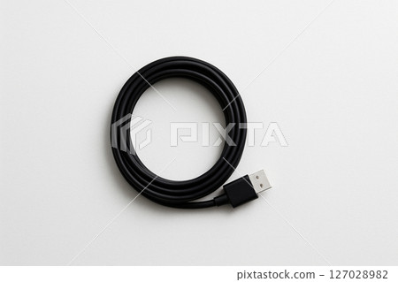 A simple black USB cable on a white background 127028982