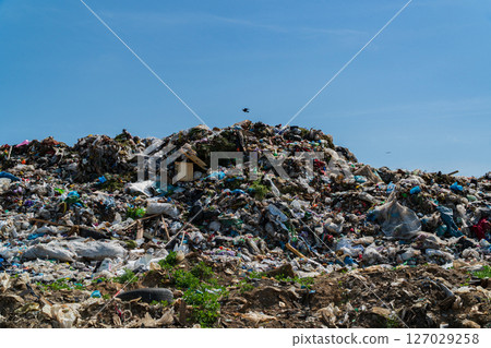 A large landfill is piled high with various forms of waste, illustrating significant pollution and environmental concerns in the area A large landfill is piled high with various forms of waste, illustrating significant pollution and environmental concerns in the area 127029258