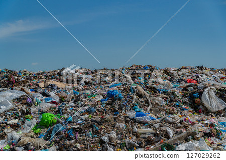 A large landfill filled with various types of waste, predominantly plastic, reflecting ongoing pollution challenges in ecological management A large landfill filled with various types of waste, predominantly plastic, reflecting ongoing pollution challenges in ecological management 127029262