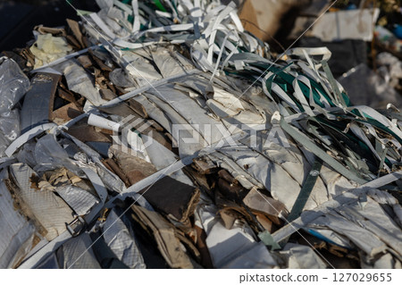Compacted waste materials are securely bound with straps at a landfill site, highlighting the challenges of pollution and waste management Compacted waste materials are securely bound with straps at a landfill site, highlighting the challenges of pollution and waste management 127029655