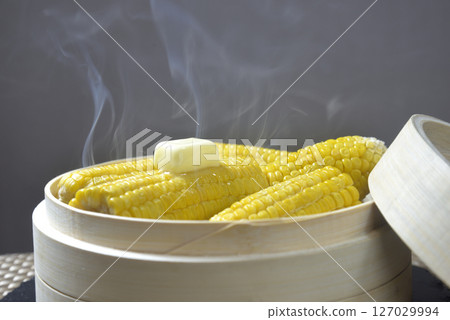 Cooking corn butter in a steamer with rising steam Cooking corn butter in a steamer with rising steam 127029994