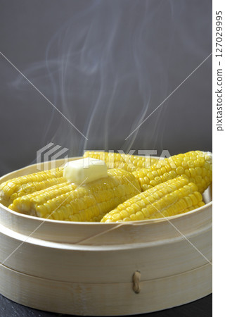 Cooking corn butter in a steamer with rising steam 127029995