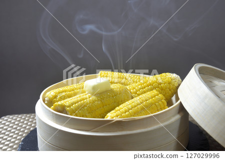 Cooking corn butter in a steamer with rising steam Cooking corn butter in a steamer with rising steam 127029996