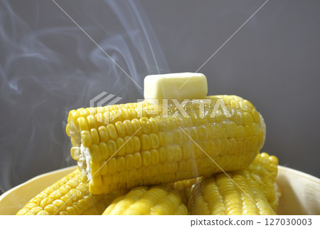 Cooking corn butter in a steamer with rising steam 127030003