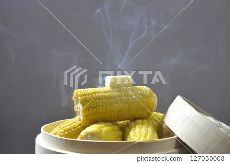 Cooking corn butter in a steamer with rising steam 127030008