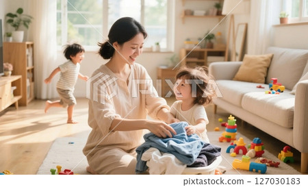 A mother playing with her child between housework A mother playing with her child between housework 127030183