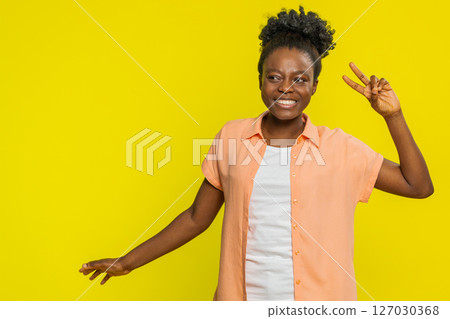 African American woman dancing with funny hand gestures, playful vibe cheerful rhythm joyful energy African American woman dancing with funny hand gestures, playful vibe cheerful rhythm joyful energy 127030368