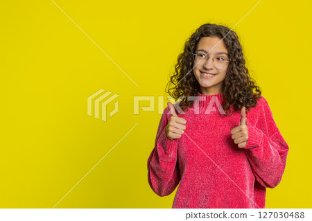 Caucasian girl raises thumbs up agrees give positive reply recommends advertisement likes good idea Caucasian girl raises thumbs up agrees give positive reply recommends advertisement likes good idea 127030488
