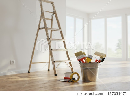 Painting supplies and ladder in a bright room getting ready for renovation 127031471