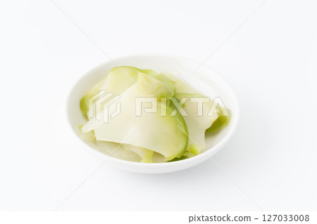 Pickled zha cai on a small plate on a white background Pickled zha cai on a small plate on a white background 127033008