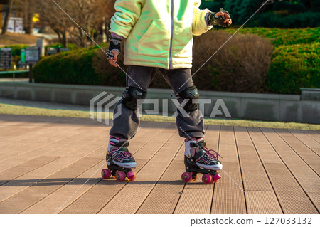Young teen girls preparing for roller-skating. Young teen girls preparing for roller-skating. 127033132