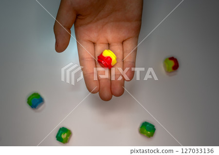 Korean traditional game kit Gonggi. Plastic stones on the palm of hand. Korean traditional game kit Gonggi. Plastic stones on the palm of hand. 127033136