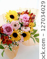 Colorful bouquet of sunflowers, gypsophila, gerberas, and roses with lights 127034029