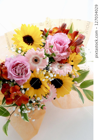 Colorful bouquet of sunflowers, gypsophila, gerberas, and roses with lights Colorful bouquet of sunflowers, gypsophila, gerberas, and roses with lights 127034029