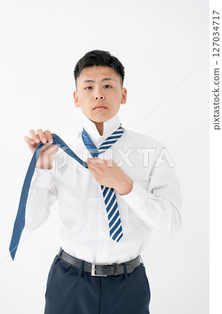 Young man tying a tie Business Young man tying a tie Business 127034717