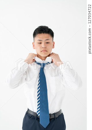 Young man tying a tie Business 127034722