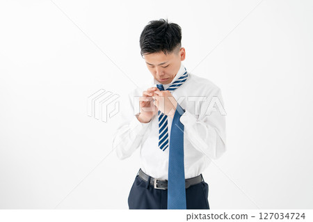 Young man tying a tie Business Young man tying a tie Business 127034724