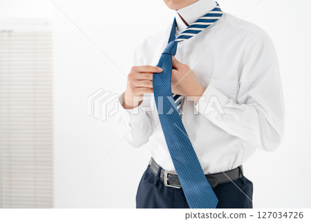 Young man tying a tie Business 127034726