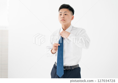 Young man tying a tie Business 127034728