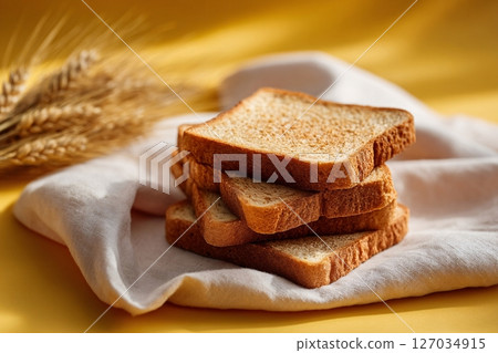 tempting graham bread in the sunny corner on a cream background, in a clean food photography style 127034915