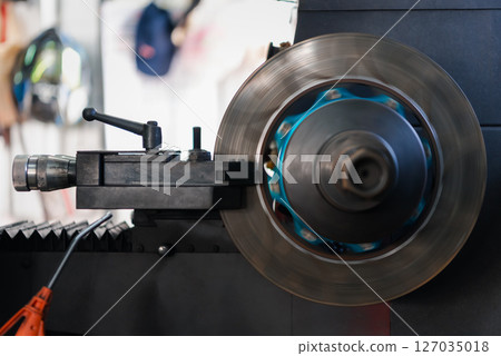 Checking car brake system for repair at car garage Checking car brake system for repair at car garage 127035018