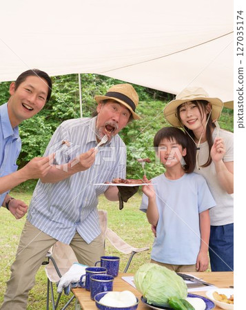 Camping friends enjoying cooking outdoors 127035174