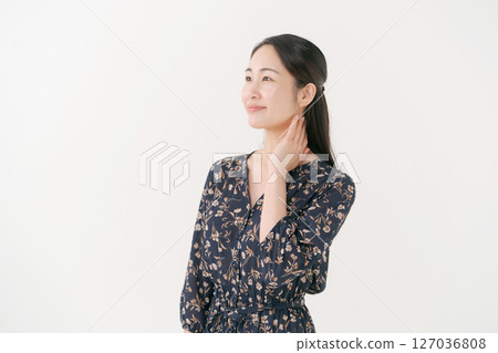 Smiling young woman in front of a white background Smiling young woman in front of a white background 127036808