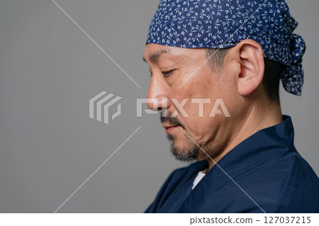 A man wearing a work uniform, profile, close-up 127037215