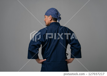 Man wearing work clothes, back view 127037217