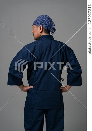 Man wearing work clothes, back view 127037218