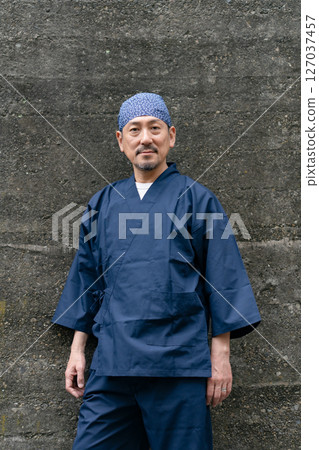 Portrait of a man wearing a work uniform Portrait of a man wearing a work uniform 127037457