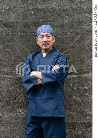 Portrait of a man wearing a work uniform Portrait of a man wearing a work uniform 127037458