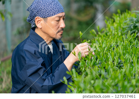 A man wearing work clothes A man wearing work clothes 127037461
