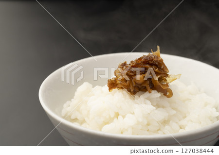 Put ginger tsukudani on freshly cooked rice 127038444