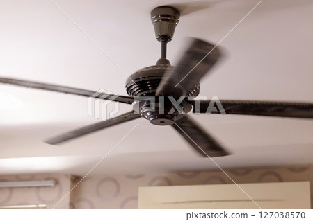 Ceiling fan hanging from the ceiling Ceiling fan hanging from the ceiling 127038570