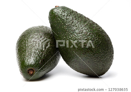 Two Ripe organic green avocado fruits isolated on white background with built-in clipping path 127038635