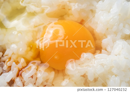 Image of soy sauce being poured onto rice with raw egg (stock photo) Image of soy sauce being poured onto rice with raw egg (stock photo) 127040232