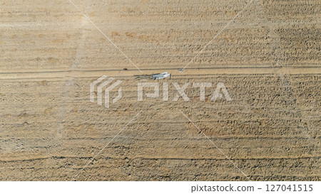 Aerial view of the rice field before plantation season in Thailand. Preparing the land is a crucial step to ensure that the saplings have sufficient access to nutrients and water. Aerial view of the rice field before plantation season in Thailand. Preparing the land is a crucial step to ensure that the saplings have sufficient access to nutrients and water. 127041515