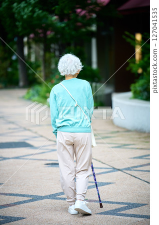 Active seniors walking with a cane Active seniors walking with a cane 127041535