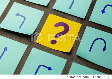 Economic uncertainty symbolized by arrows and a question mark, reflecting volatility and lack of clear direction 127041607