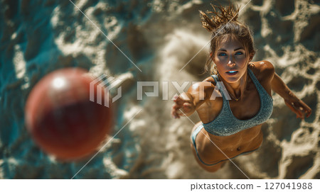 Dynamic upward shot captures a beautiful athlete reaching for a basketball 127041988