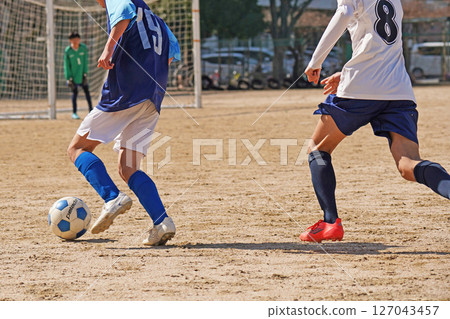 Youth soccer match (player dribbling) Youth soccer match (player dribbling) 127043457